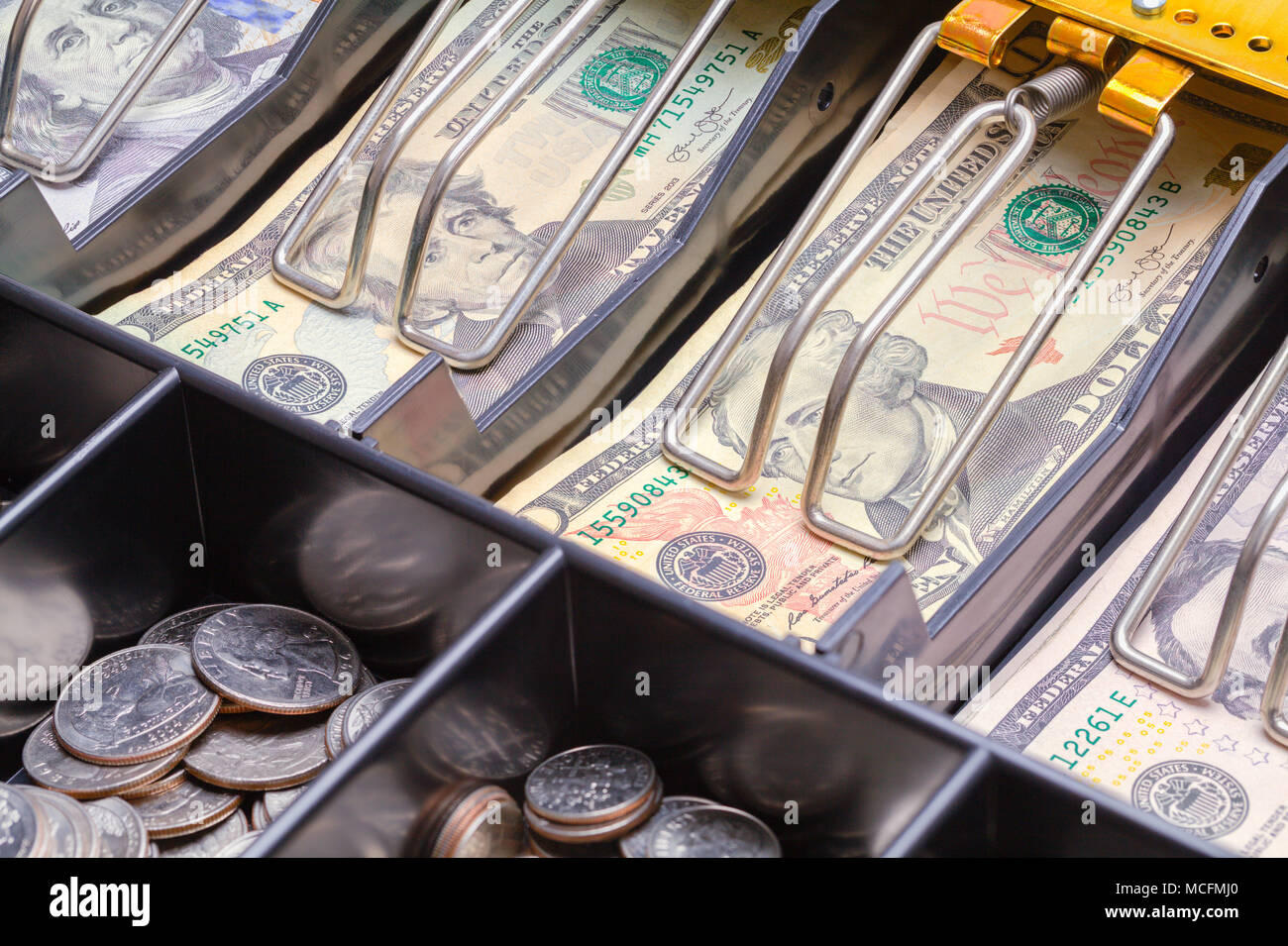 Open cash drawer with U.S. bills
