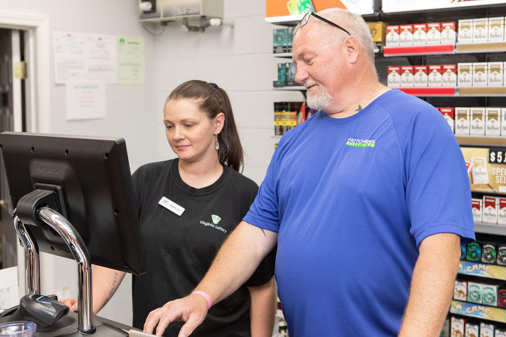 Clerk and customer at a Virginia Lottery terminal