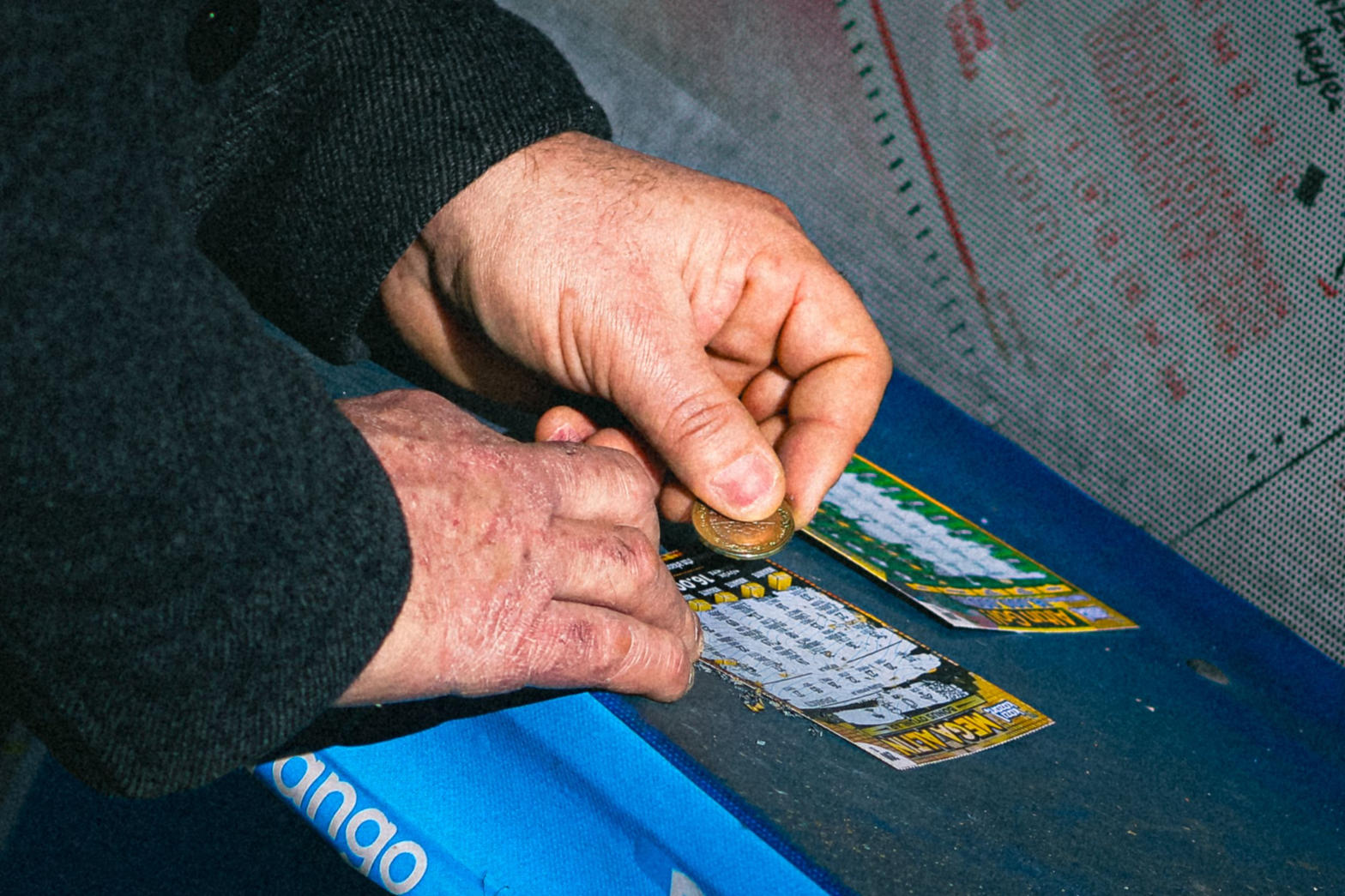 Hands scratching lottery tickets