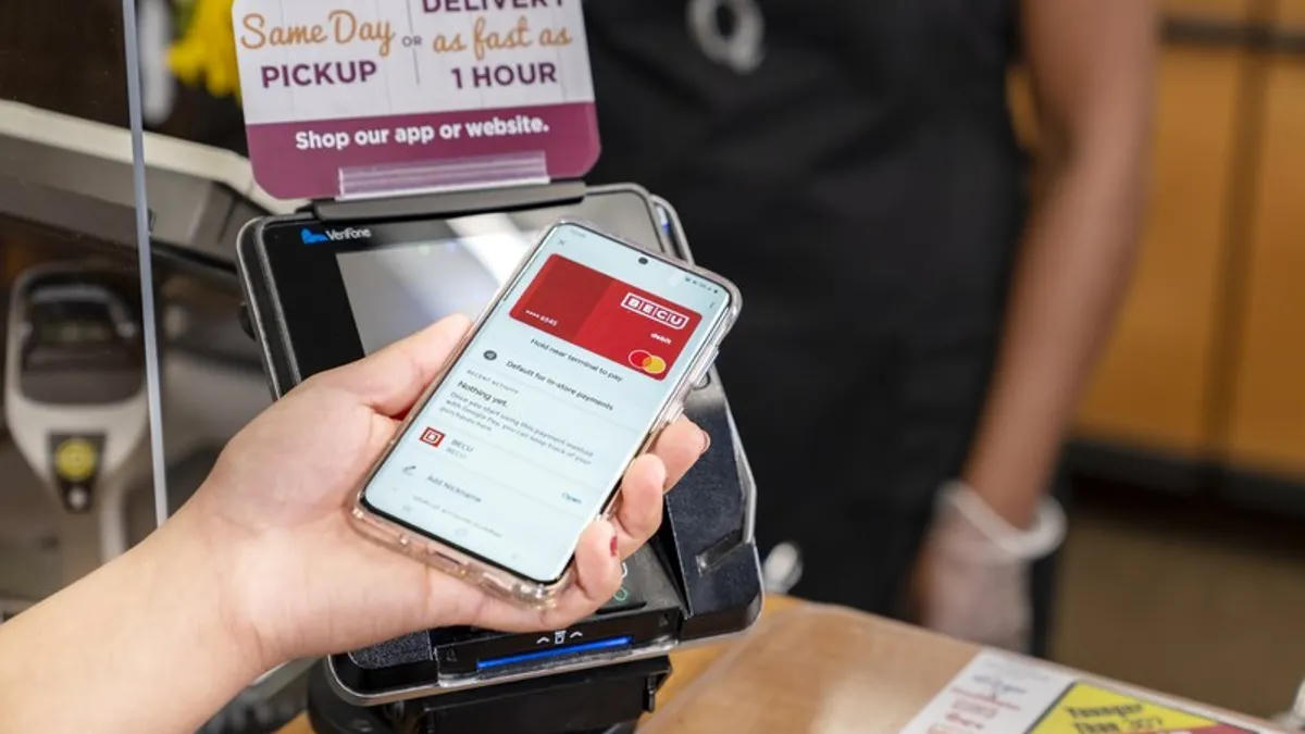 Customer tapping a phone to pay